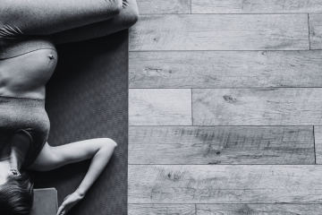 pregnant person in a yoga mat stretching